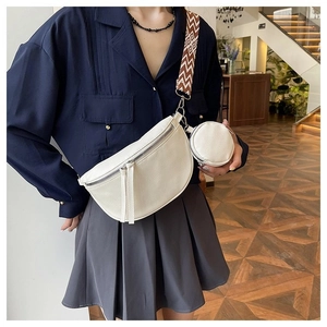 Detail of white saddle bag with retro geometric strap and small round coin purse