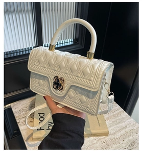Detailansicht der weißen Stepptasche mit goldenem Kleeblatt-Verschluss für Damen