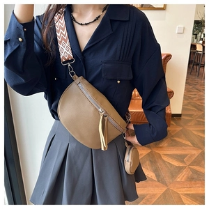 Khaki pebbled leather chest bag with round pouch and jacquard strap on model