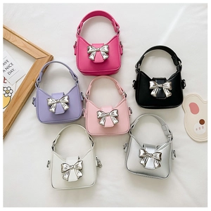 Detailed flat lay of mini bow handbags in six colors with metallic ribbon buckles