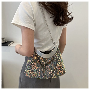 Détail du sac à bandoulière en sequins irisés avec chaîne argentée et poignée chic