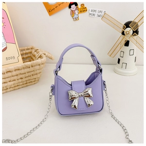 Detail of purple mini crossbody bag with metallic silver bow and elegant chain strap
