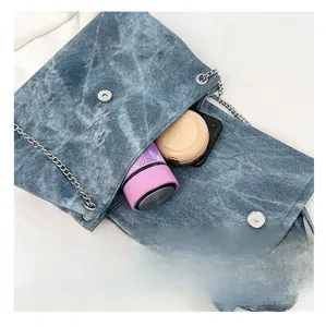 Macro view of blue denim tote bag interior showing capacity for phone and cosmetics