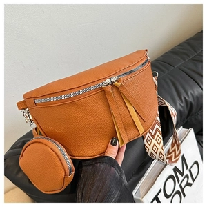 Detail of brown litchi pattern leather crossbody bag with wide strap and coin purse