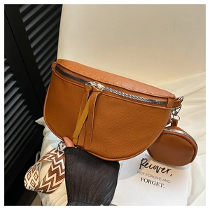 Detail of brown pebbled leather waist bag set with geometric woven wide strap