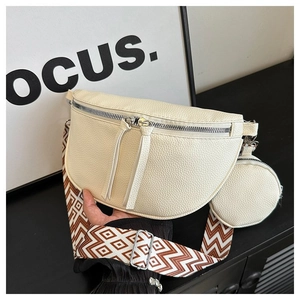 Detail view of cream lychee leather fanny pack set with geometric woven strap and round pouch