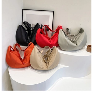 Detail showcasing five colorful nylon hobo bags with adjustable shoulder straps on a display