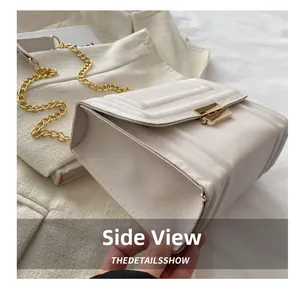 Detailed side view of off-white square shoulder bag with wide quilting and gold chain