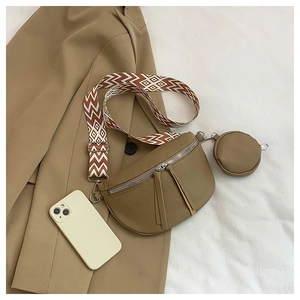 Flat lay of khaki crescent crossbody bag with ethnic strap and mini round coin purse