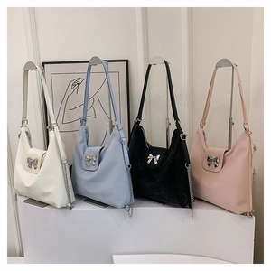 Hobo style handbags with chain straps and metallic bow details in four elegant colors