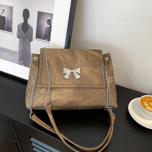 Brown washed canvas tote bag with silver butterfly chain and wide shoulder strap
