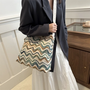 Detail of colorful bohemian striped woven velvet tote with a wide geometric shoulder strap