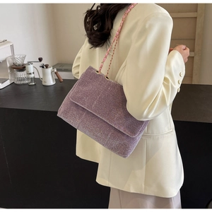 Detail view of the purple glitter chain tote bag featuring a metallic shimmer texture