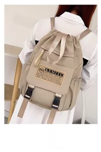 Detailed view of khaki nylon backpack with adjustable straps and secure buckle closure