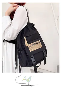 Side view of black drawstring backpack with flap and buckle on a male model