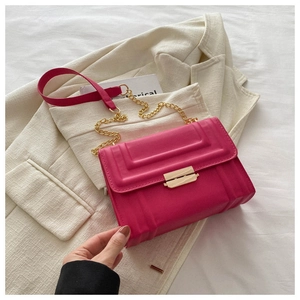 Detail of rose pink crossbody bag with 3D rectangular embossing and gold buckle