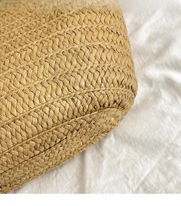 Detailed macro view of woven straw tote bag texture with natural beige fibers