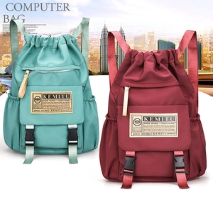 Detail view of large capacity waterproof nylon backpacks in mint green and burgundy colors