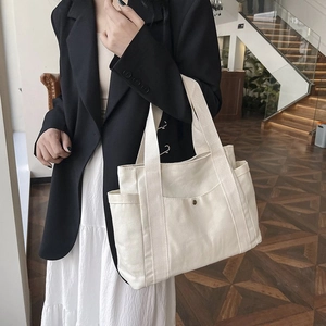 Large capacity white canvas tote bag with front pocket and side compartments for commuting