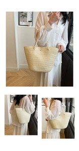 Detail of cream woven tote bag with white rope shoulder straps and metal hardware