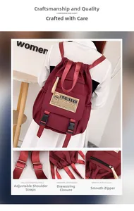Detail view of burgundy waterproof backpack showing buckles, drawstrings and side pockets