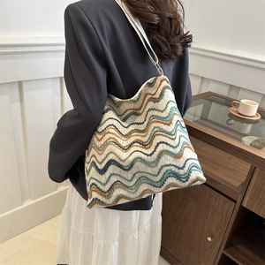 Close-up of colorful wavy knit tote bag with striped texture and large capacity design