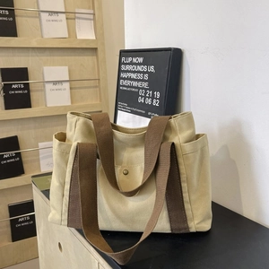 Close-up of canvas tote bag side pocket and durable fabric texture in casual style