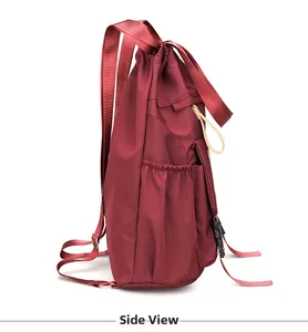 Side view of dark red durable nylon backpack showing elastic side pocket and metal strap ring