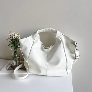 Close-up of white soft PU leather tote bag showing fine texture and silver hardware details