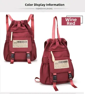 Detail view of burgundy nylon backpacks with drawstring closure and front flap pockets