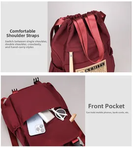 Detail of burgundy nylon backpack with reinforced straps and spacious front pocket storage