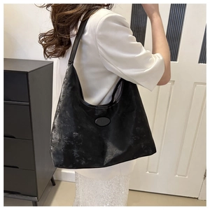 Detail view of black Hobo bag with vintage silver coating and leather shoulder strap