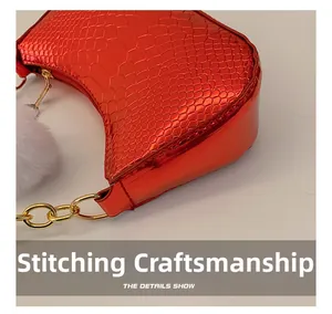 Close-up of red crocodile embossed shoulder bag featuring precise stitching and texture