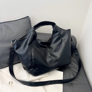 Chic black large capacity tote bag in smooth faux leather for fashion commute