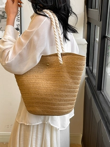 Large woven straw tote bag with white cotton rope handles for summer beach casual style