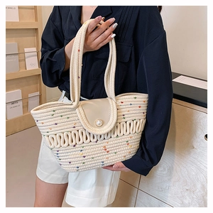 Detailed shot of crochet shoulder bag with wave pleats and a large pearl button closure
