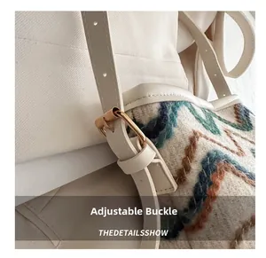 Detail shot of the adjustable gold buckle and woven tweed fabric on the shoulder strap