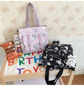 Detail of printed canvas tote bags featuring cute bear patterns and front buckle pockets