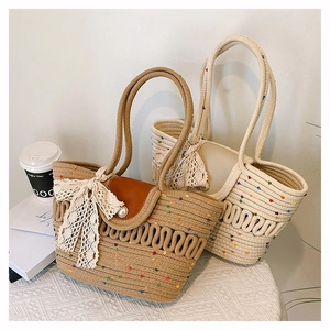 Detail of bohemian woven beach bags with colorful polka dots, lace bows and pearl buttons