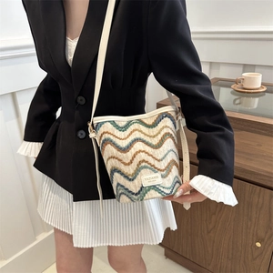 Striped knit bucket bag with wave patterns and leather strap for women in 2024 fashion
