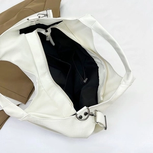 Detail view of large white tote bag showing spacious black lining and internal pockets