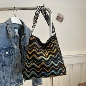 Detail of chevron woven velvet tote with a wide geometric pattern adjustable strap