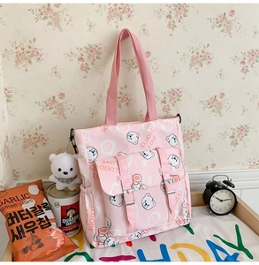Pink canvas tote bag with cute bear print, front buckle pockets, and fluffy bear keychain