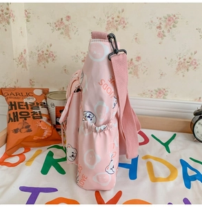 Detail view of pink student tote bag with cartoon bear print and side elastic pocket