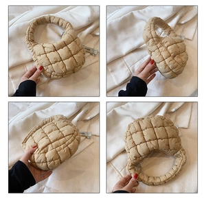 Detailed close-up showing beige quilted bubble bag with padded square texture and soft handle