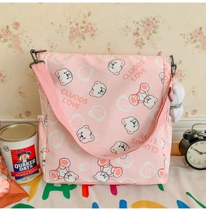 Detailed close-up of a pink Harajuku tote bag with cute bear patterns and plush charm