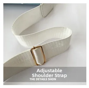Close-up of the adjustable white woven shoulder strap with premium gold metal buckle