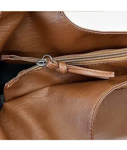 Close-up of silver zipper detail on brown pebbled leather casual tote bag