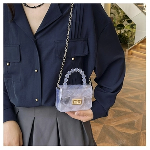 Détail du mini sac gelée transparent avec matelassage losange et poignée perlée