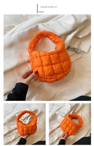 Detail of a bright orange quilted cloud bag showing vibrant color and padded texture